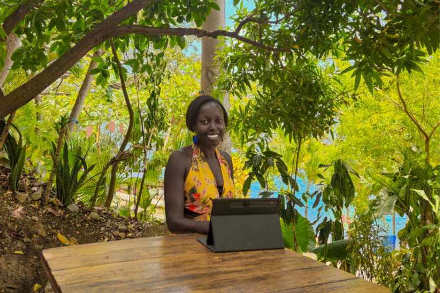 Ina aan het werk buiten met de laptop in de weelderige natuur